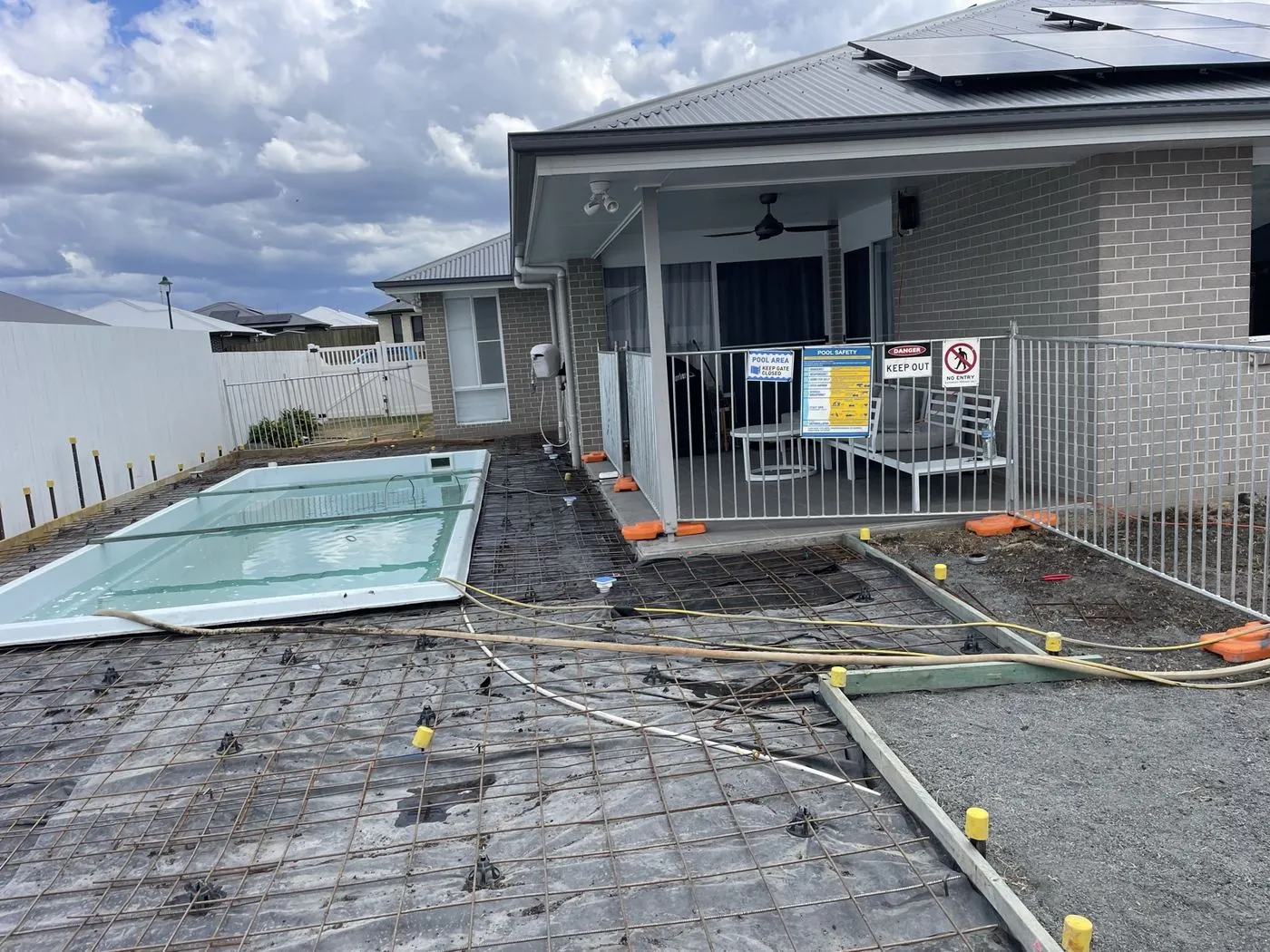 Fibreglass pool shell set in the ground, reinforcement laid for the bond beam